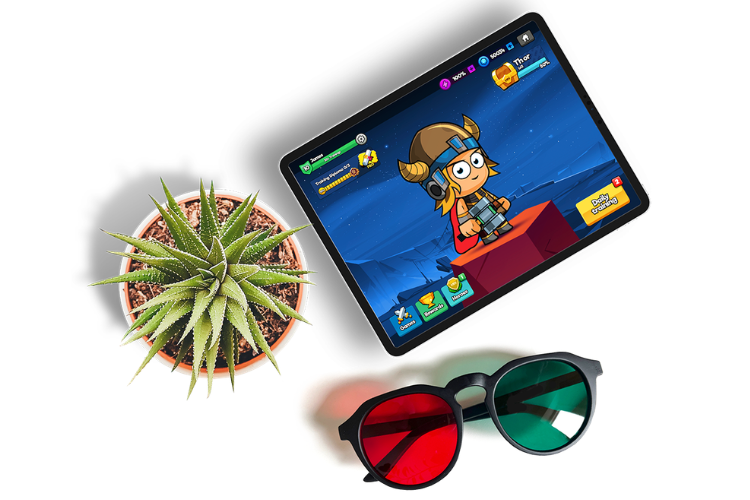 Tablet displaying Eye Hero vision training app game alongside specialized red-green glasses and a potted plant.