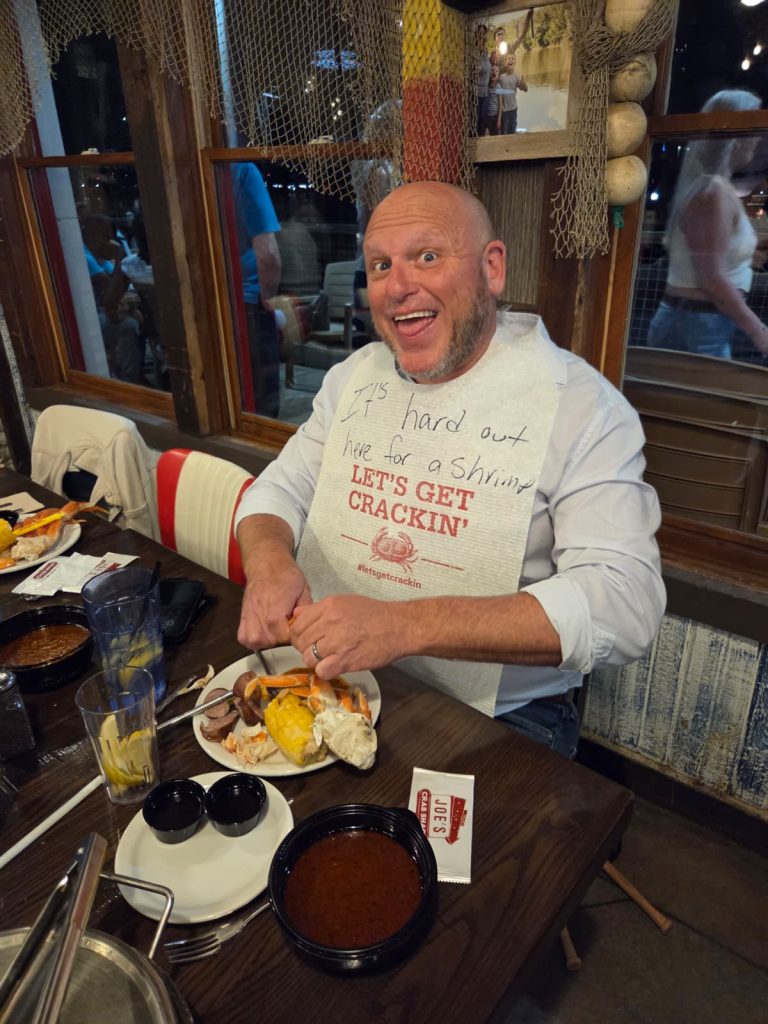 Attendee enjoying a seafood meal at the Eye Hero event in Louisville