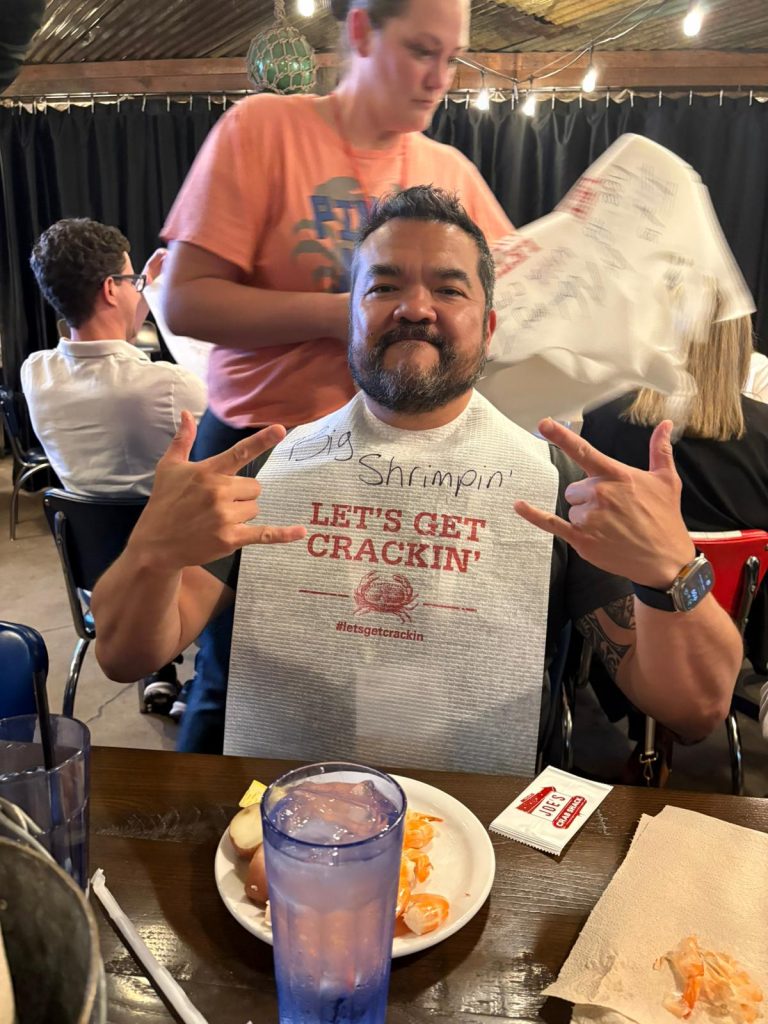 Eye care professional enjoying seafood and atmosphere at the Eye Hero Louisville gathering