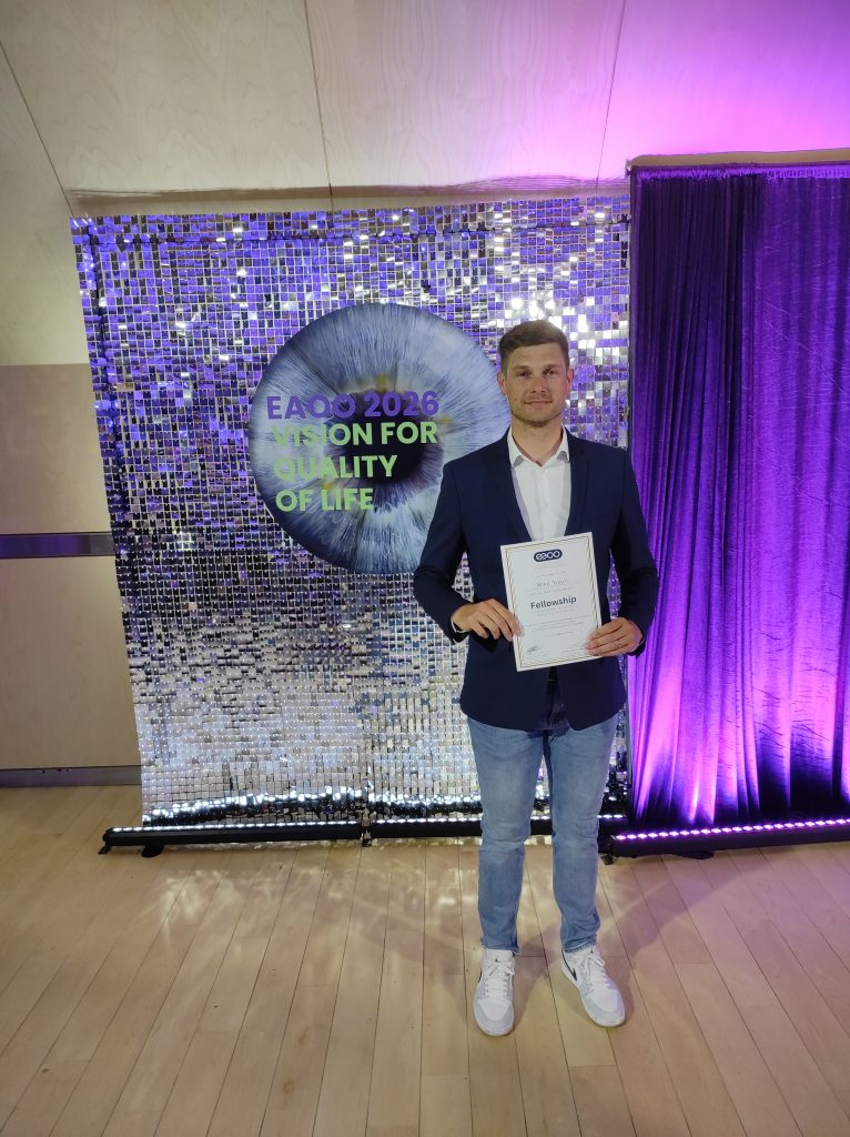 Matic Vogric holding his European Academy of Optometry and Optics Fellowship certificate