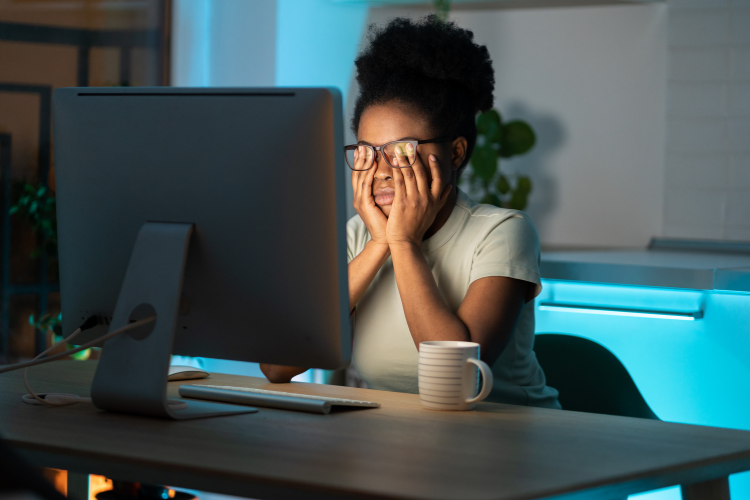 Woman experiencing eye strain while working at a computer