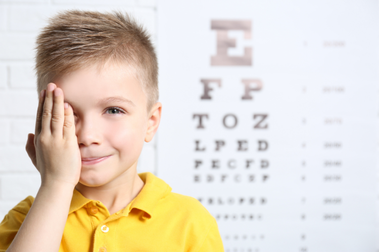Child having an eye exam with a 20/20 vision chart